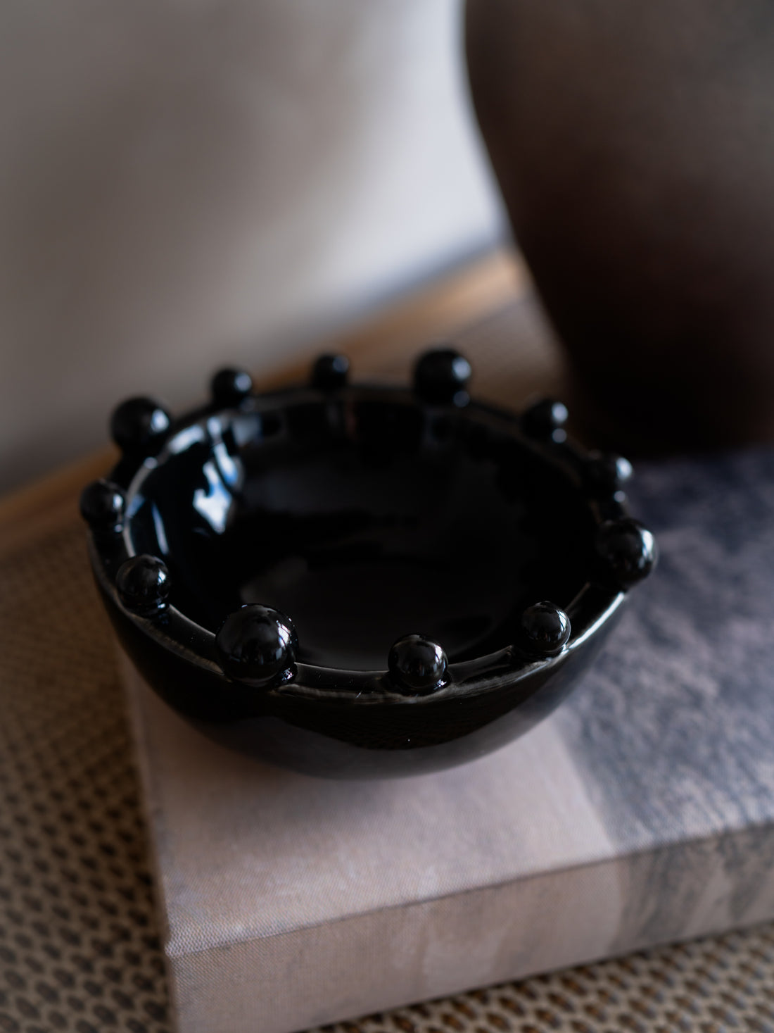 Black decorative bowl on a textured surface