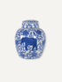 A blue and white porcelain ginger jar featuring a blue elephant motif surrounded by floral patterns, set against a solid off-white background. Timeless Chinoiserie inspired design.