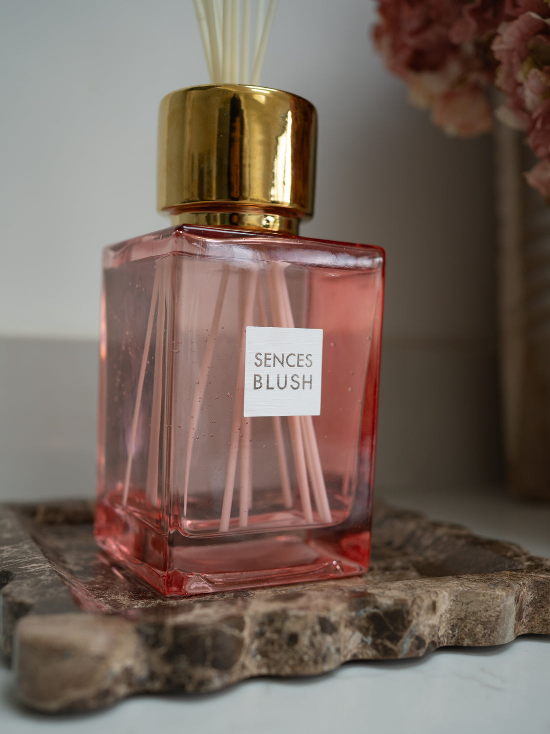 Pink luxury reed diffuser bottle labeled &