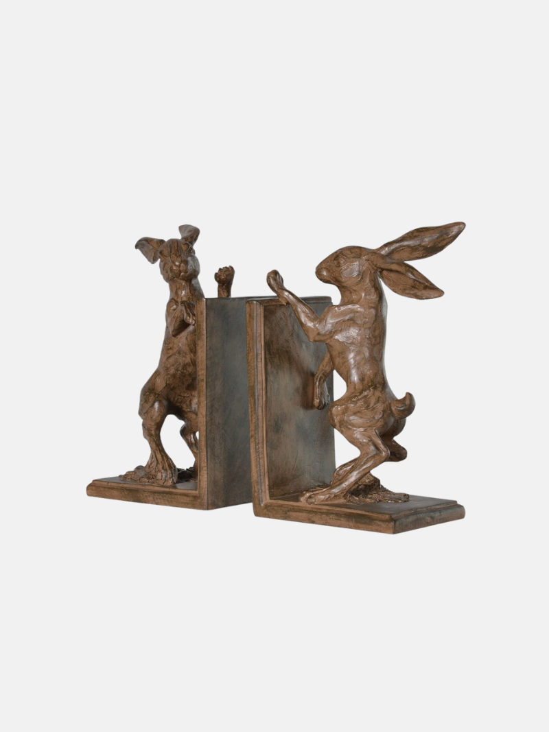 Bronze bookends shaped like boxing hares on a white background