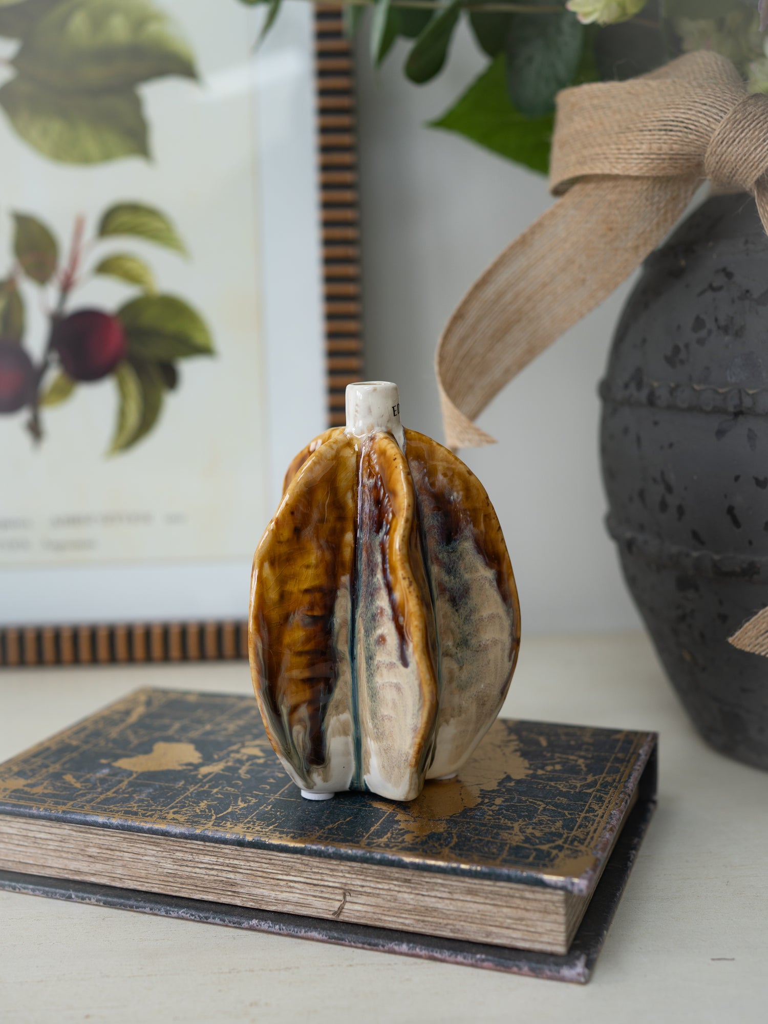 Decorative ceramic vase on a vintage book with a blurred background