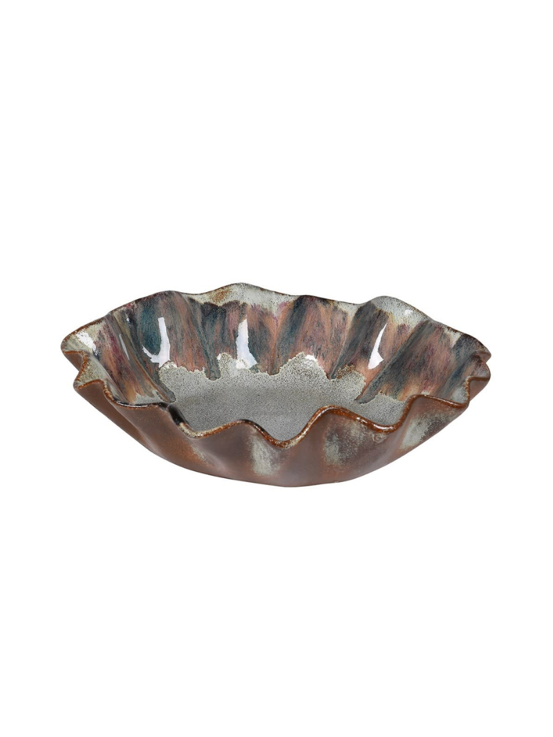 Decorative ceramic bowl with wavy edge on a white background
