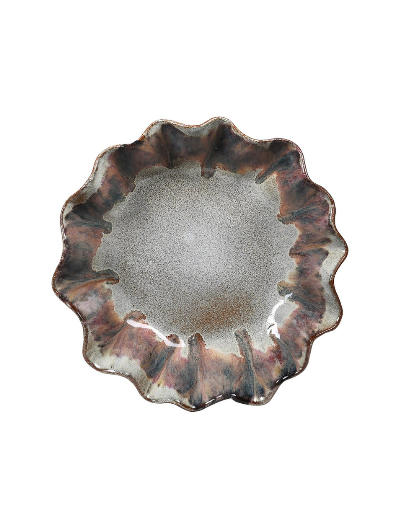 Ceramic plate with wavy edge on a white background
