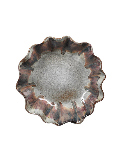 Ceramic plate with wavy edge on a white background