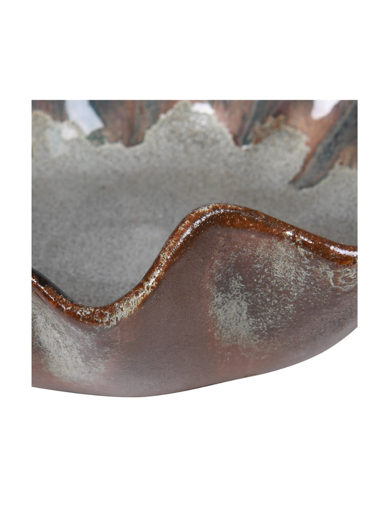 Close-up of a ceramic bowl with a textured surface on a white background
