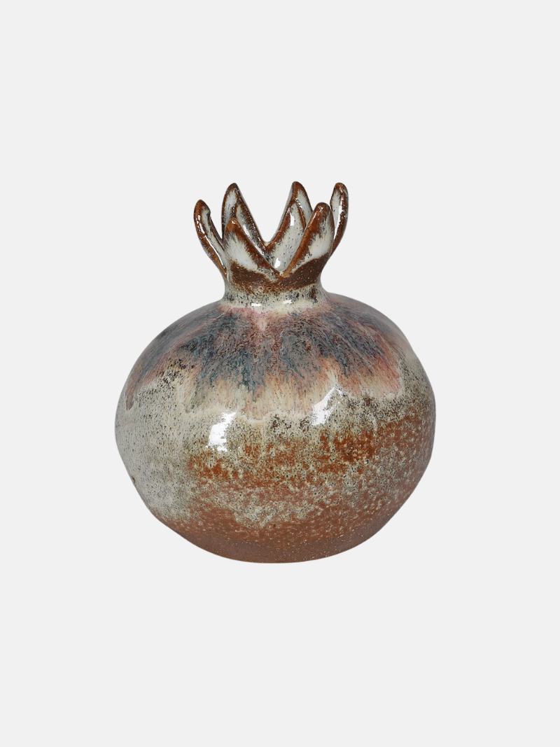 Ceramic vase with a textured surface and decorative top on a light gray background