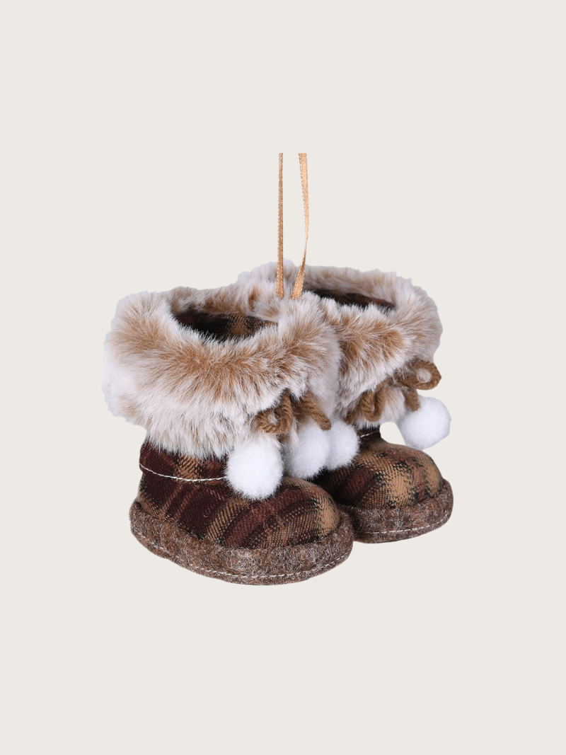 Decorative boot ornaments with fur and pom-poms on a beige background