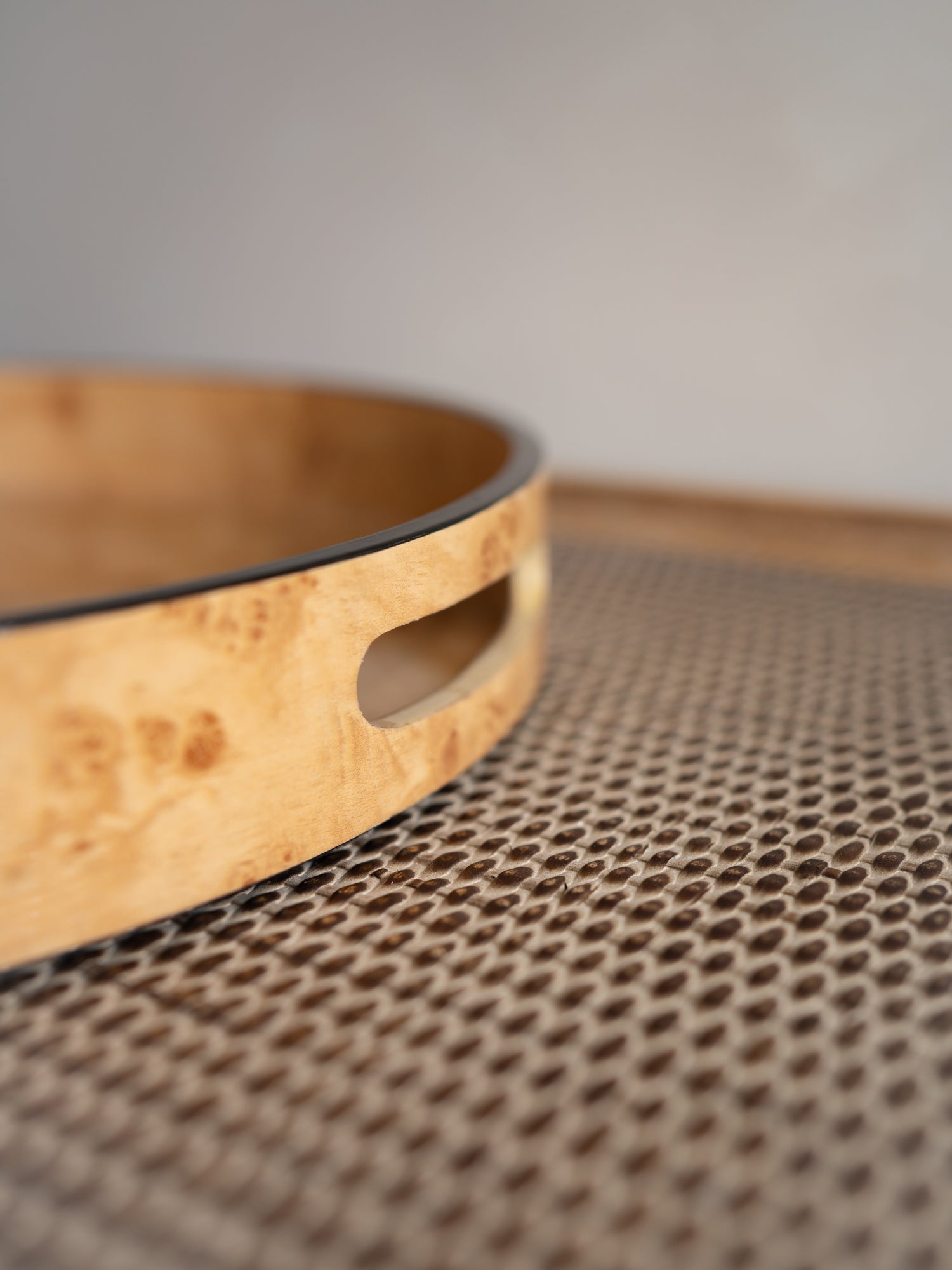 Wooden tray with a handle on a textured surface