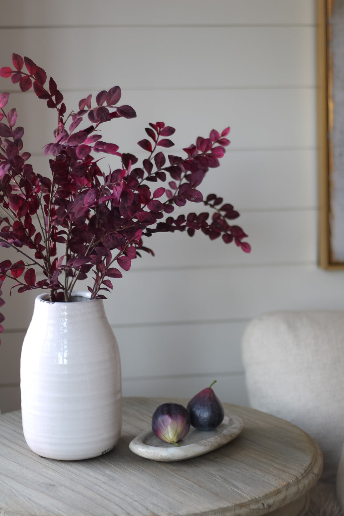 Faux Plum Mini Leaves Spray in distressed white ceramic vase 
