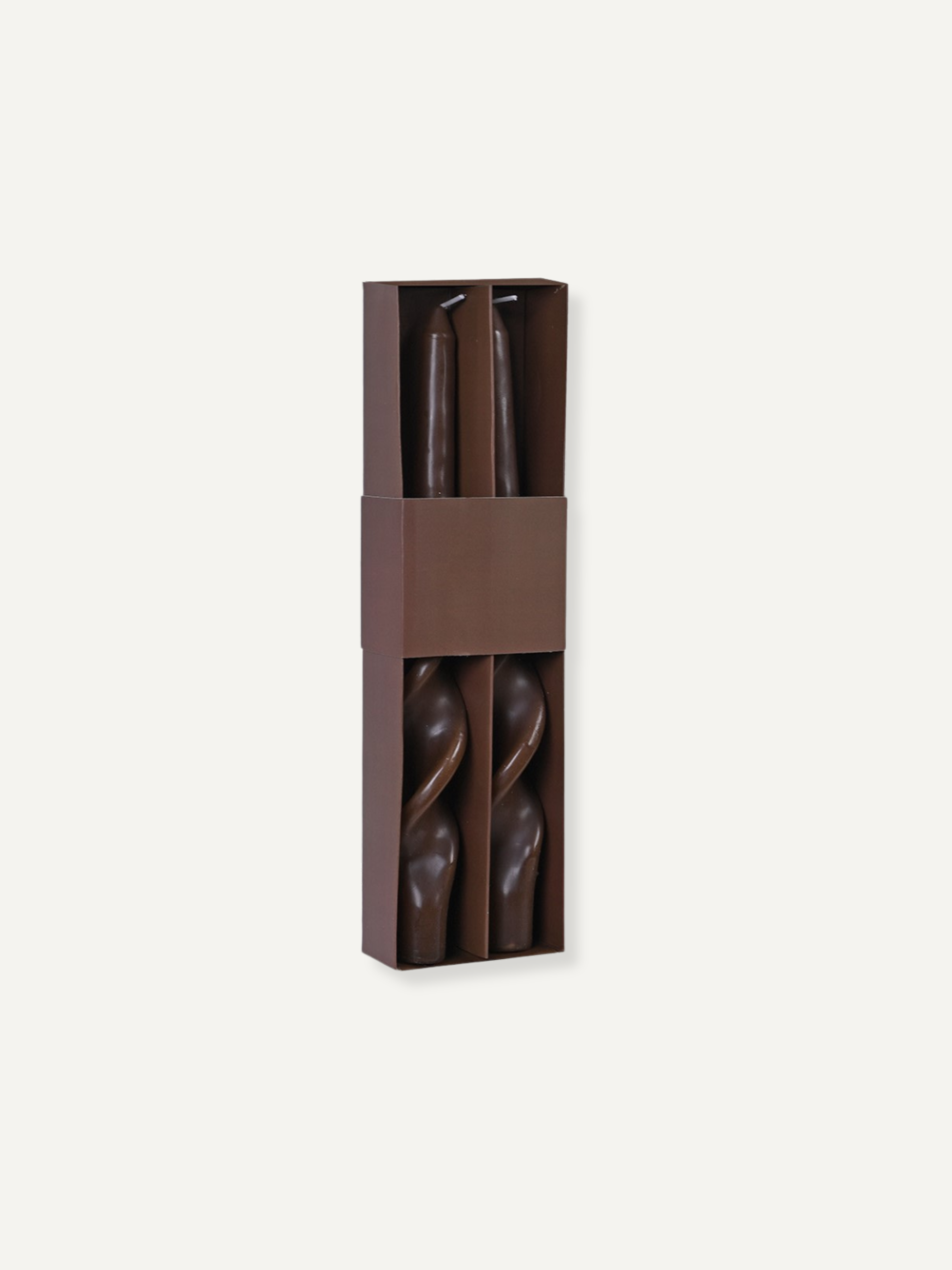 Pair of caramel twisted dinner candles in a brown packaging box on a white background