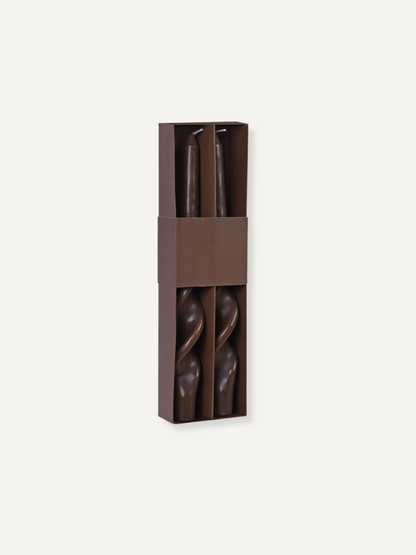 Pair of caramel twisted dinner candles in a brown packaging box on a white background