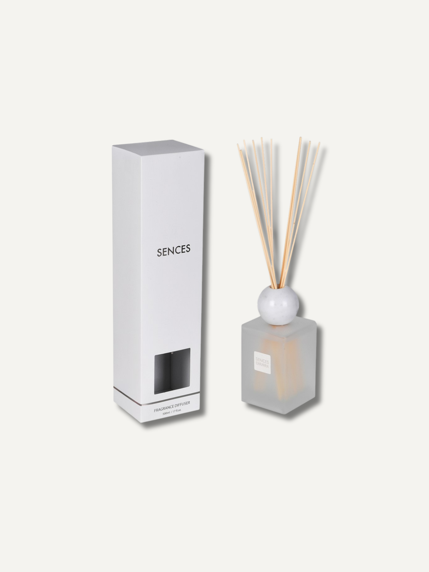 A reed diffuser set with a frosted glass bottle, natural reed sticks, and a tall white rectangular box labeled &