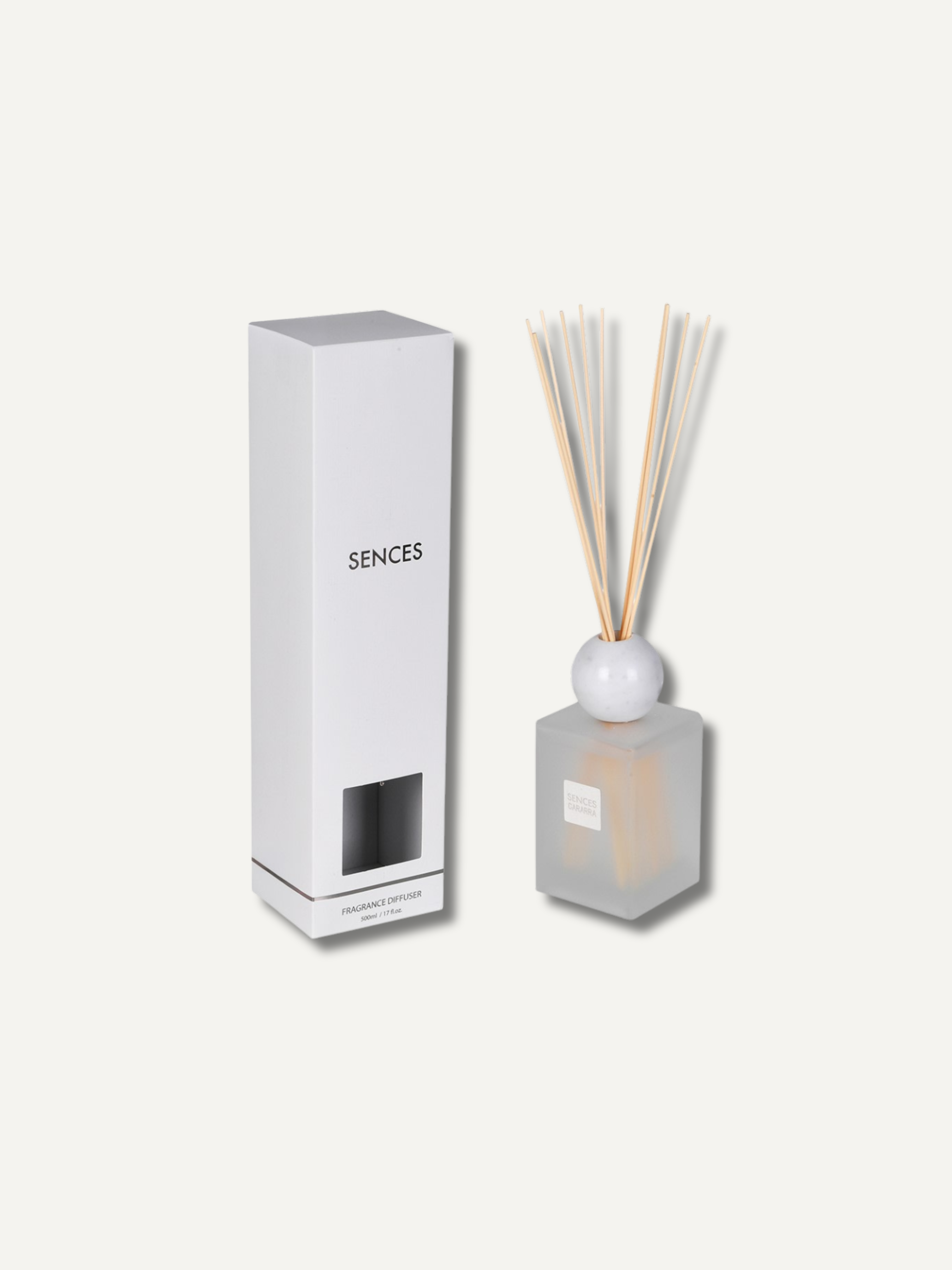 A reed diffuser set with a frosted glass bottle, natural reed sticks, and a tall white rectangular box labeled &
