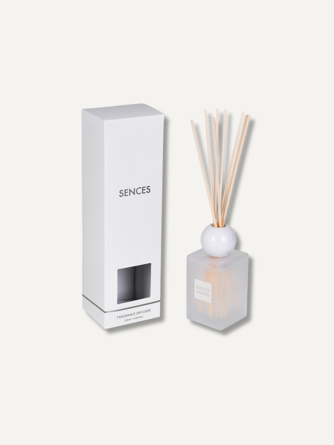 A reed diffuser set with a frosted glass bottle, natural reeds, and a white spherical top, shown next to its tall white packaging box on a light beige background.