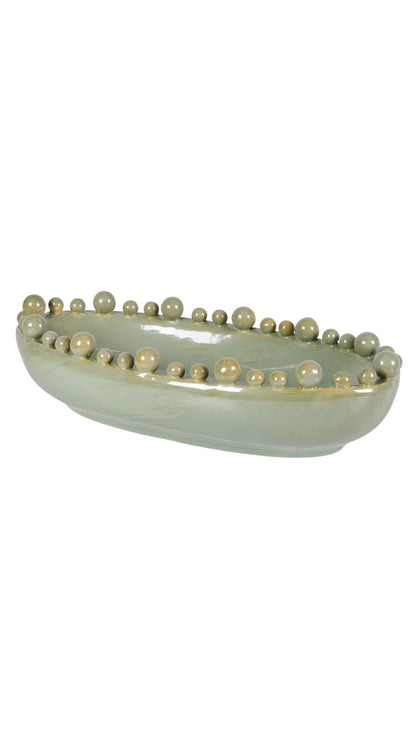 Decorative ceramic bowl with pearl-like bobbles on a white background