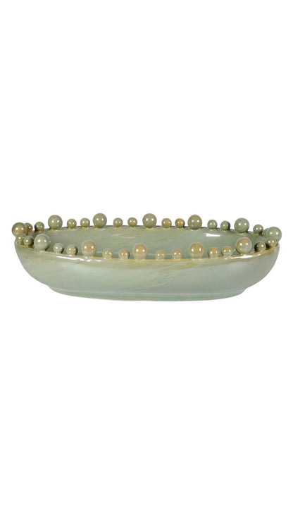 Decorative bowl with bobble-like beads on a white background