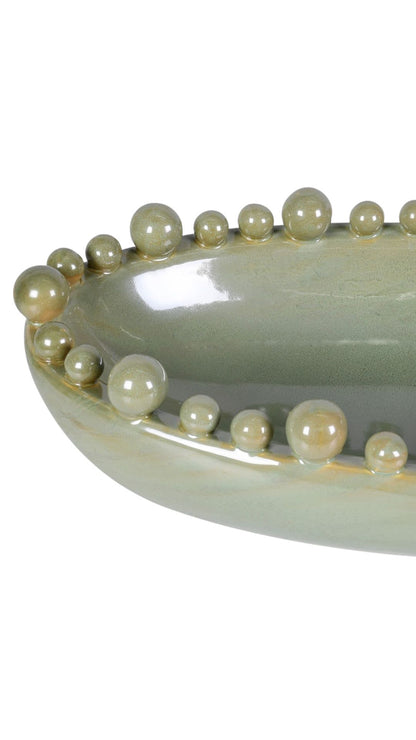 Decorative bowl with pearl-like bobbles on a white background