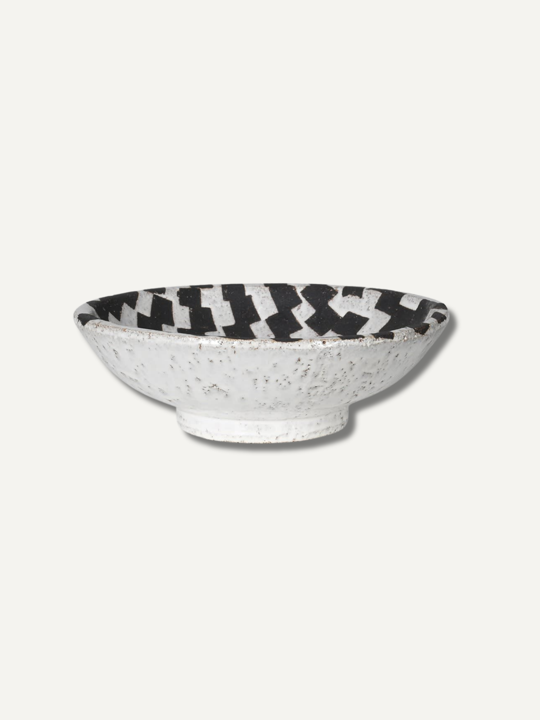 Ceramic bowl with black and white checkered pattern on a white background