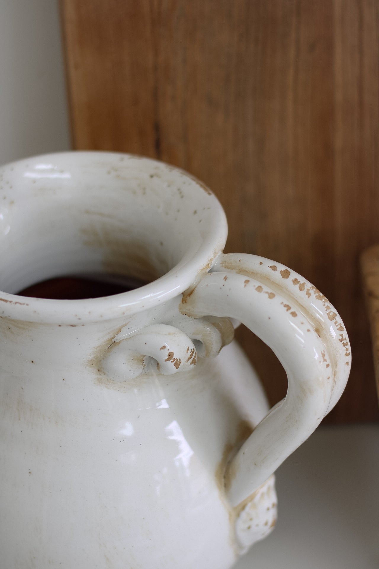 White ceramic jug on a wooden surface