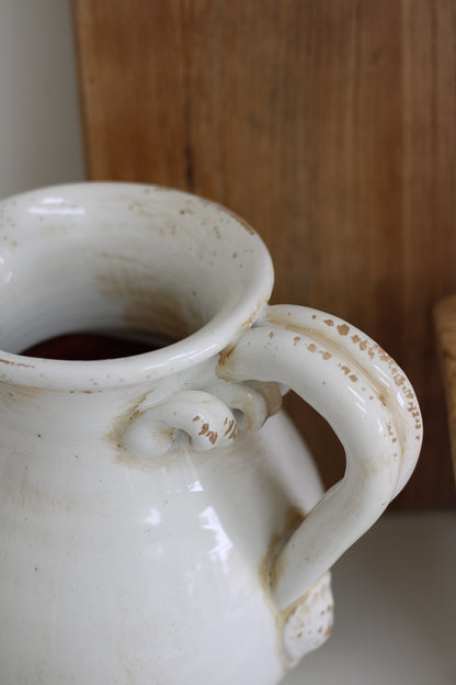 White ceramic jug on a wooden surface