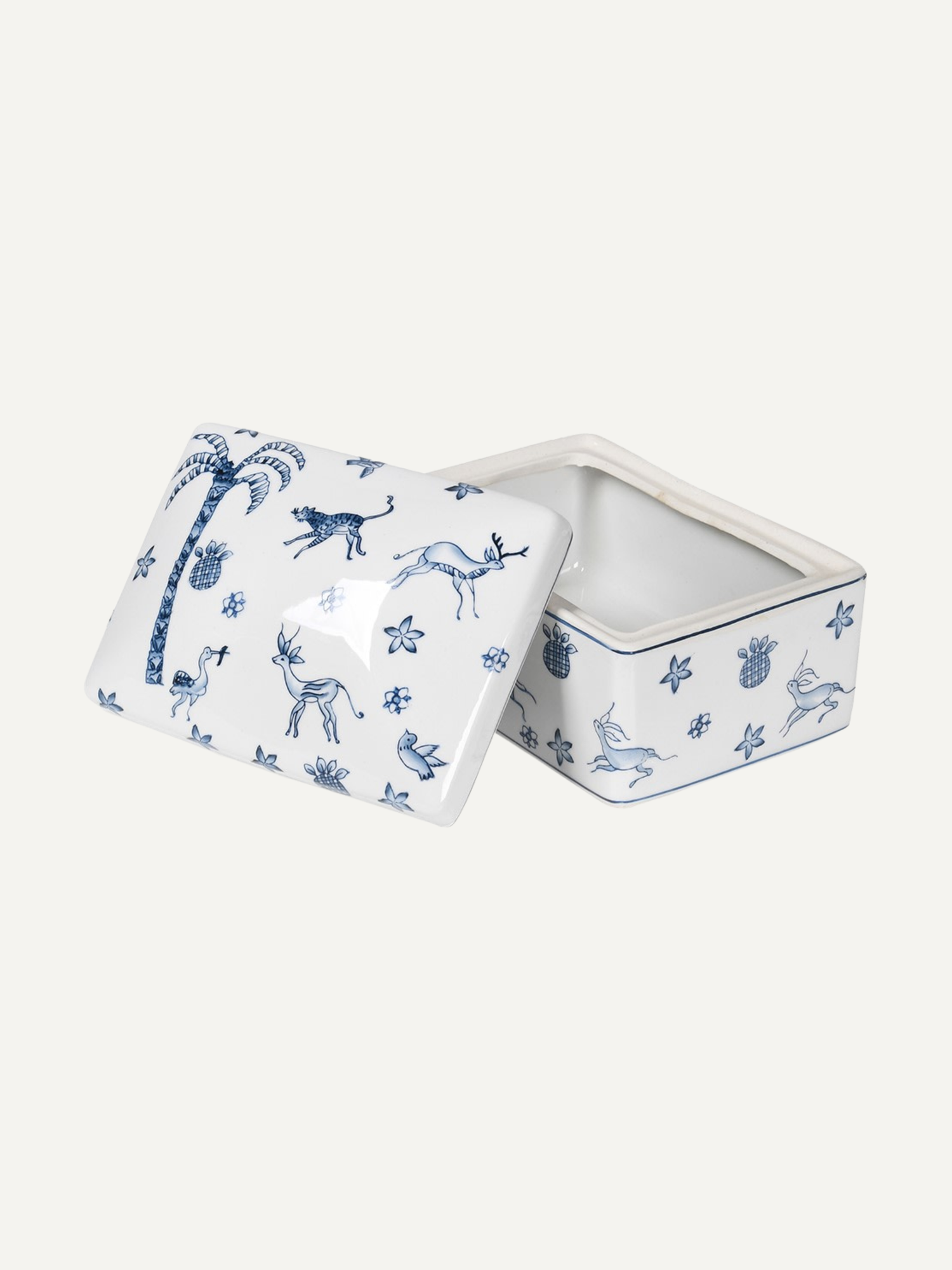 White ceramic trinket box with blue animal patterns on a white background