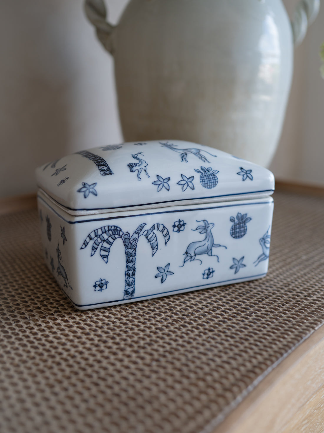 Small decorative ceramic box with blue patterns on a textured surface