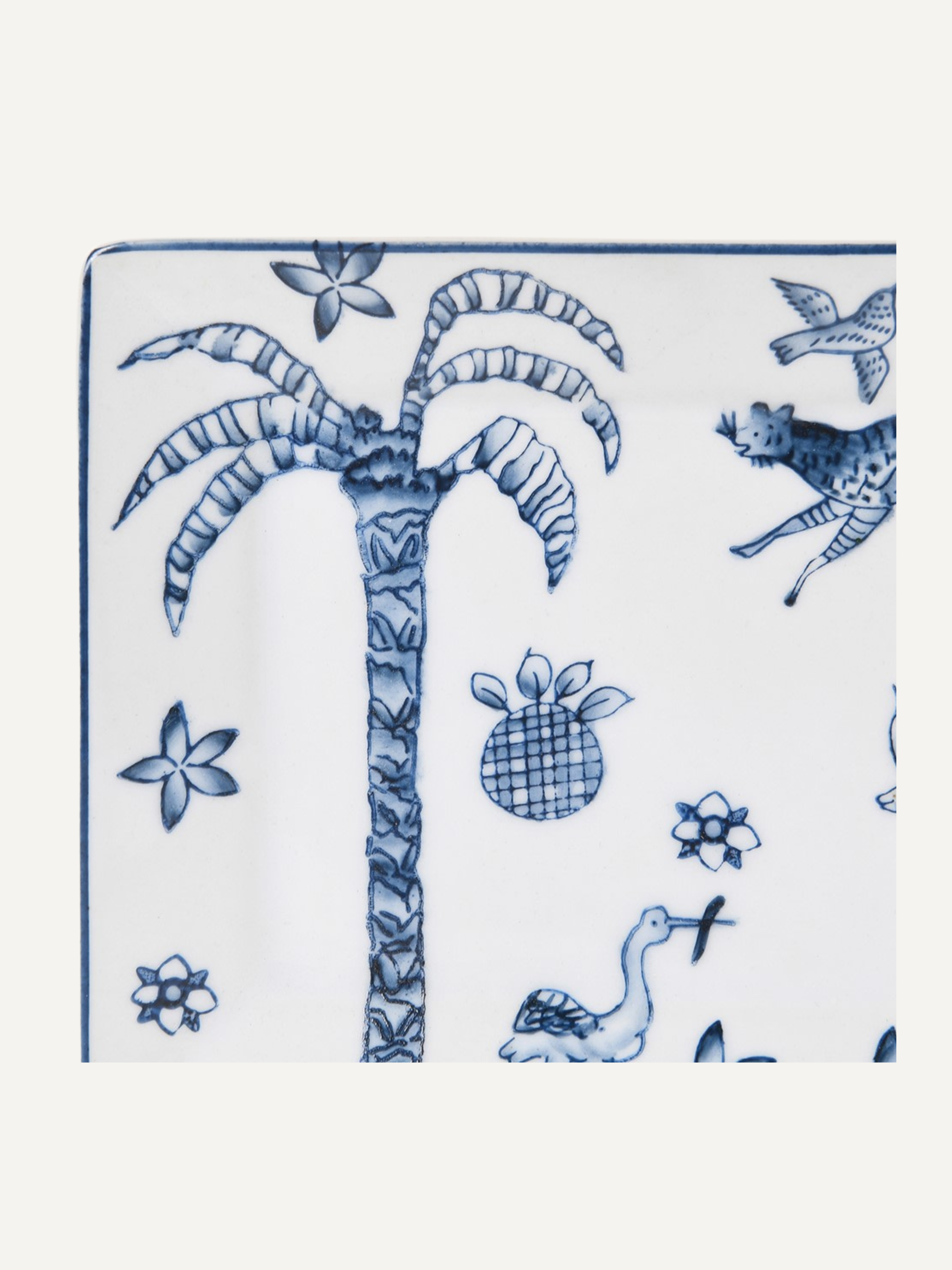 Blue and white ceramic trinket tray with palm tree and bird design