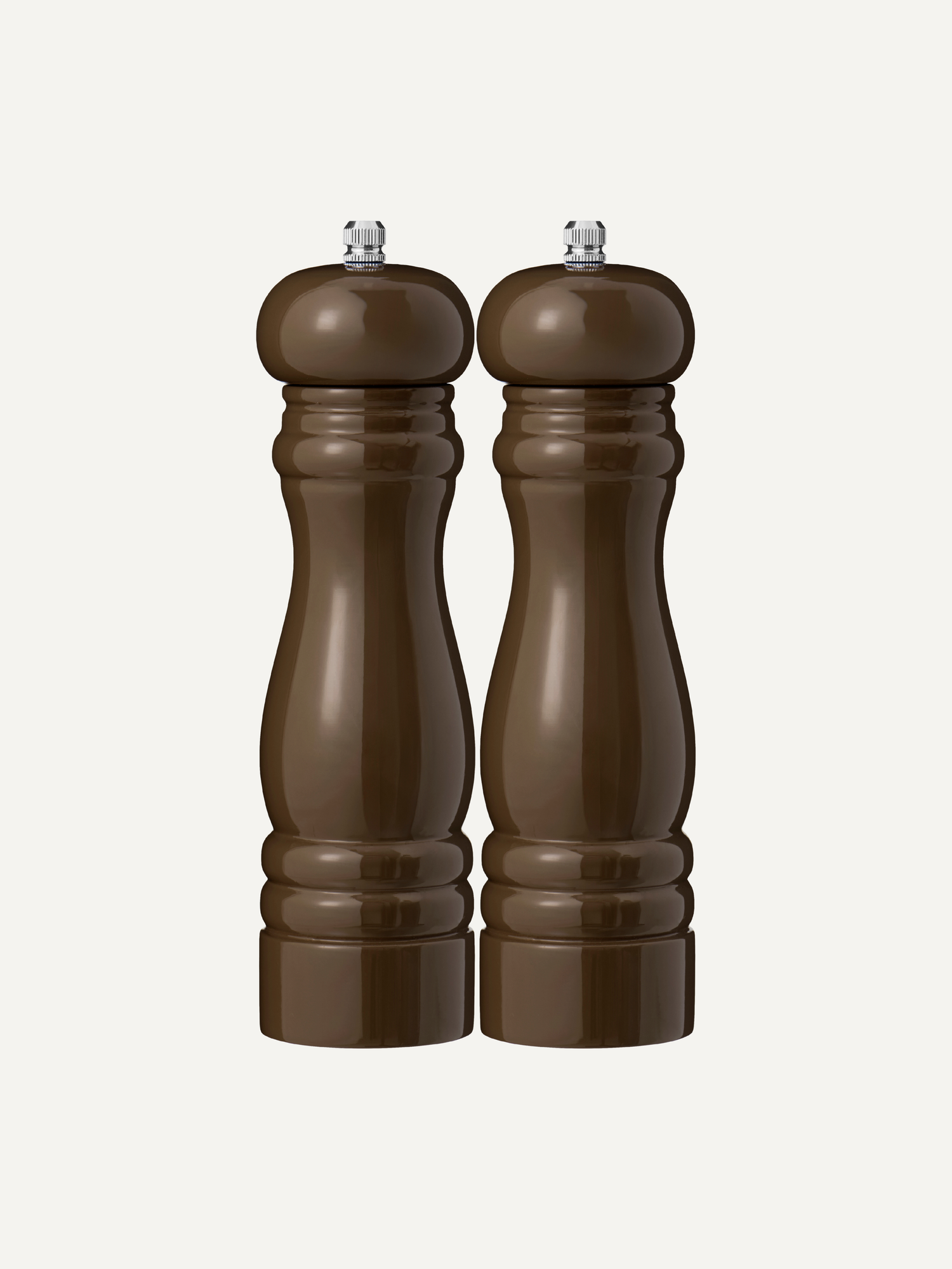Two chocolate dark brown wooden salt and pepper mills with silver metal tops, standing side-by-side against a light off-white background.