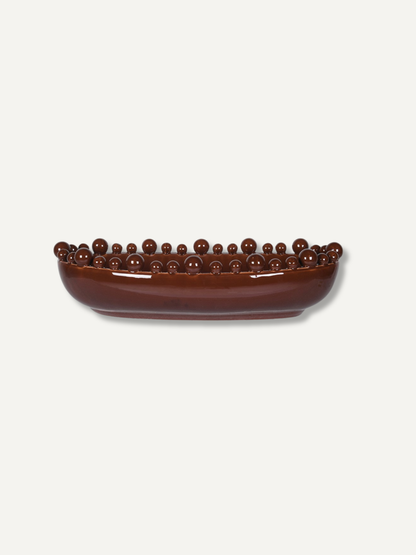 A glossy dark brown ceramic bowl with a raised rim of small spherical beads, shown on a plain light gray background.