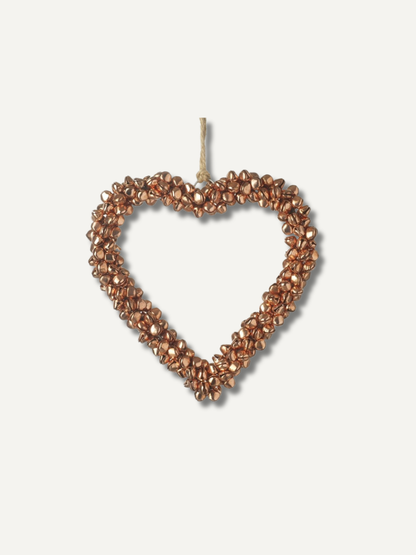 A heart-shaped hanging ornament made of small metallic copper or bronze beads with a natural twine loop at the top, shown against a plain off-white background.