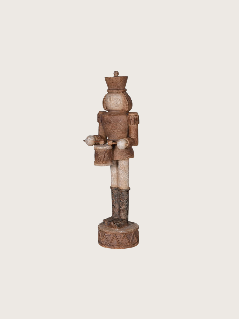 Wooden nutcracker figure on a beige background