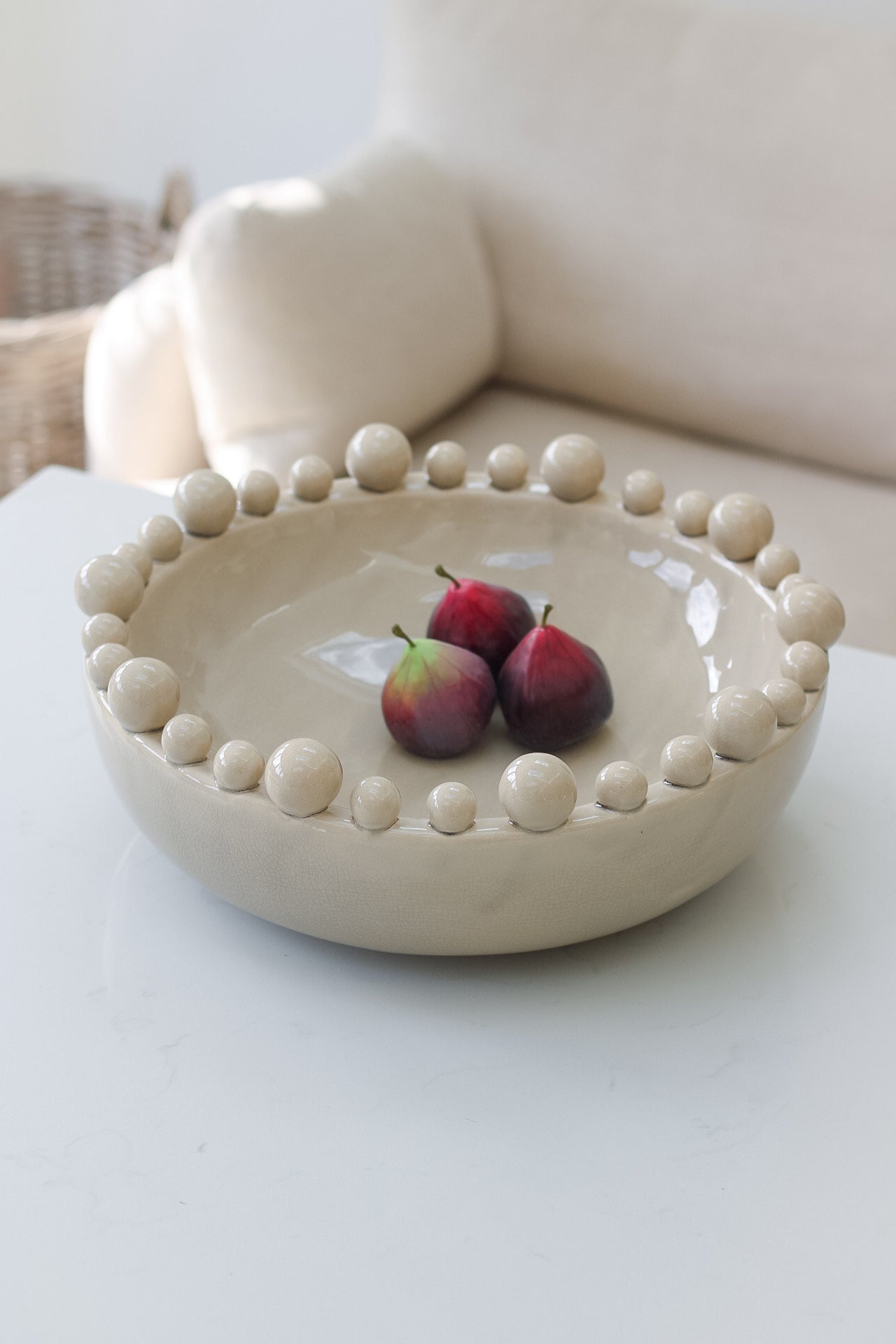 Faux figs in decorative bowl