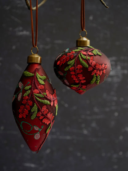 Decorative red ornaments with floral patterns on a dark background