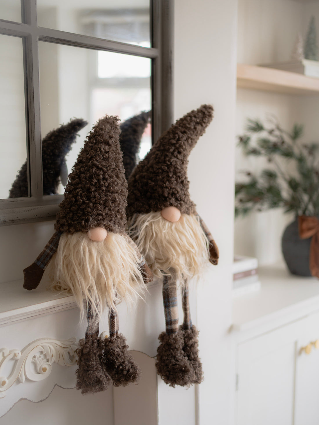 Two decorative gnomes with long beards in a home setting.