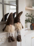 Two decorative gnomes with long beards in a home setting.