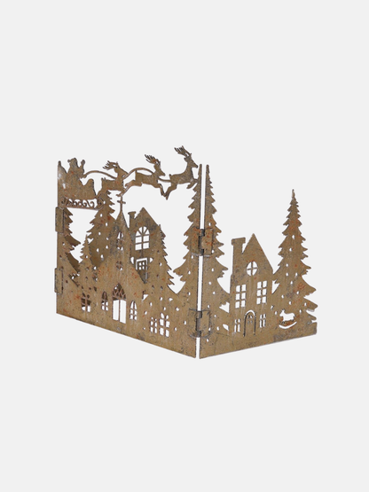 Decorative cut-out of a forest scene with buildings and trees on a white background
