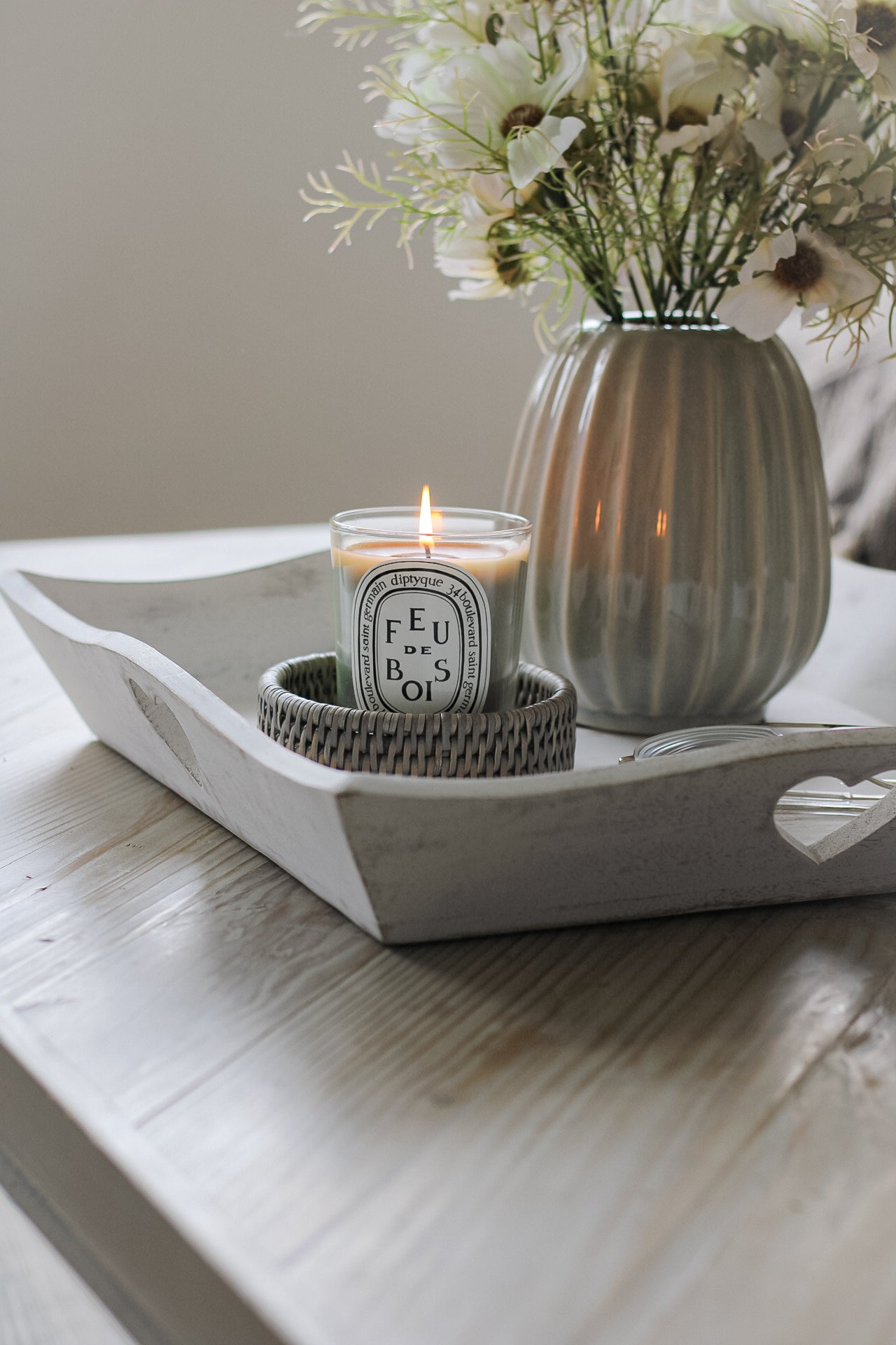 wooden tray with flowers in vase and candle