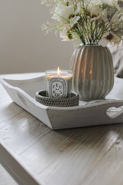wooden tray with flowers in vase and candle