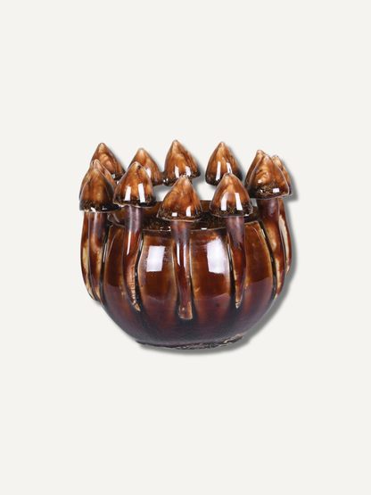 Decorative brown mushroom ombre candle holder with pointed ends on a light gray background for home decor