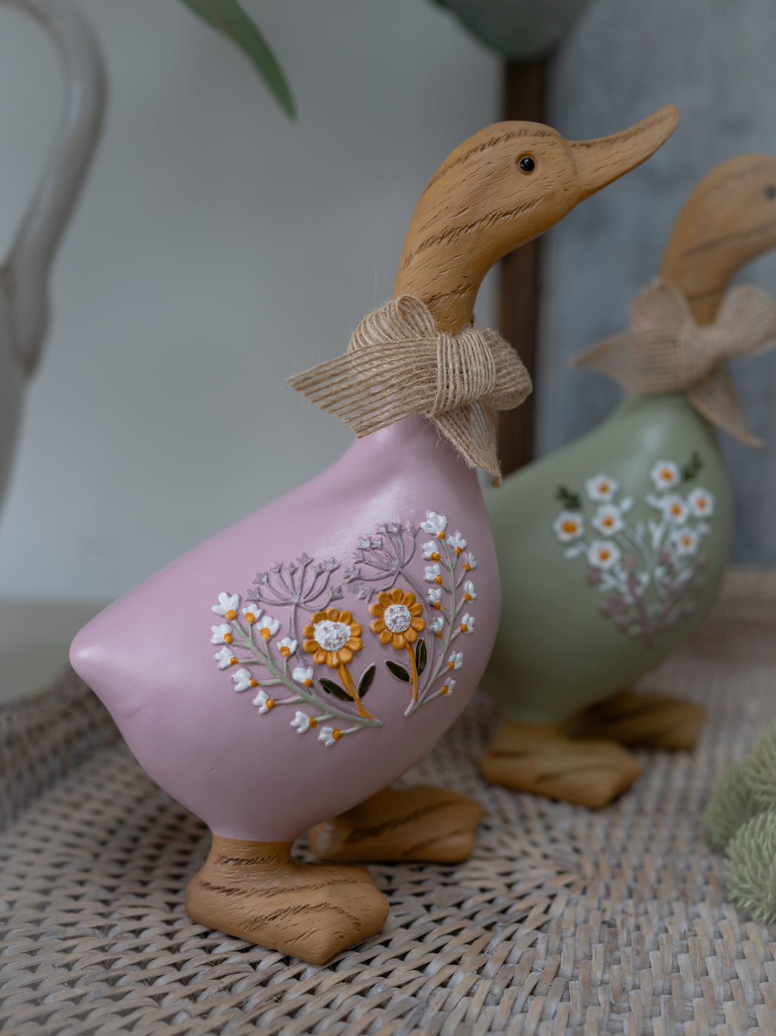 Decorative duck figurine with floral design on a textured surface