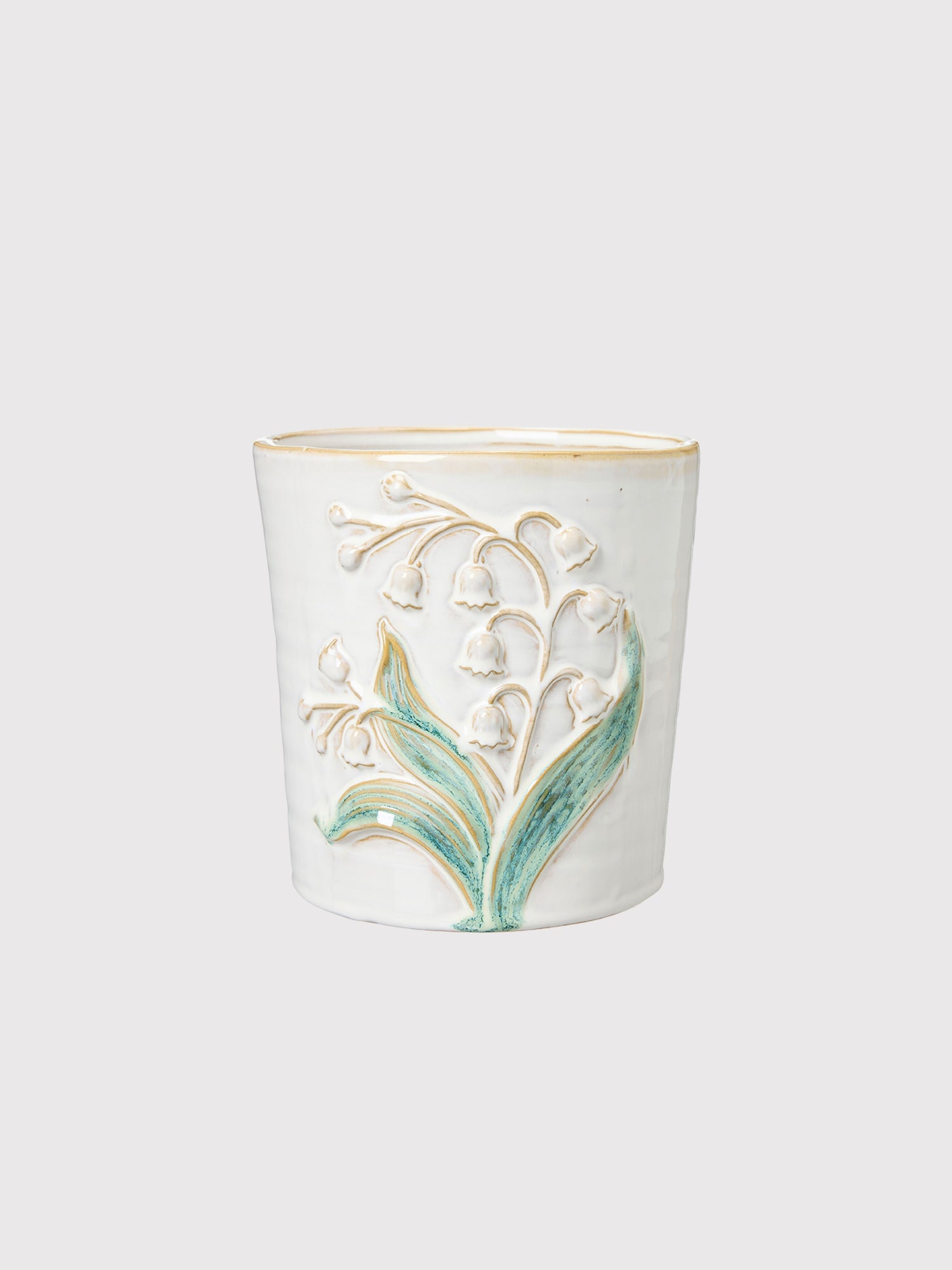 Ceramic candle holder with floral design on a white background
