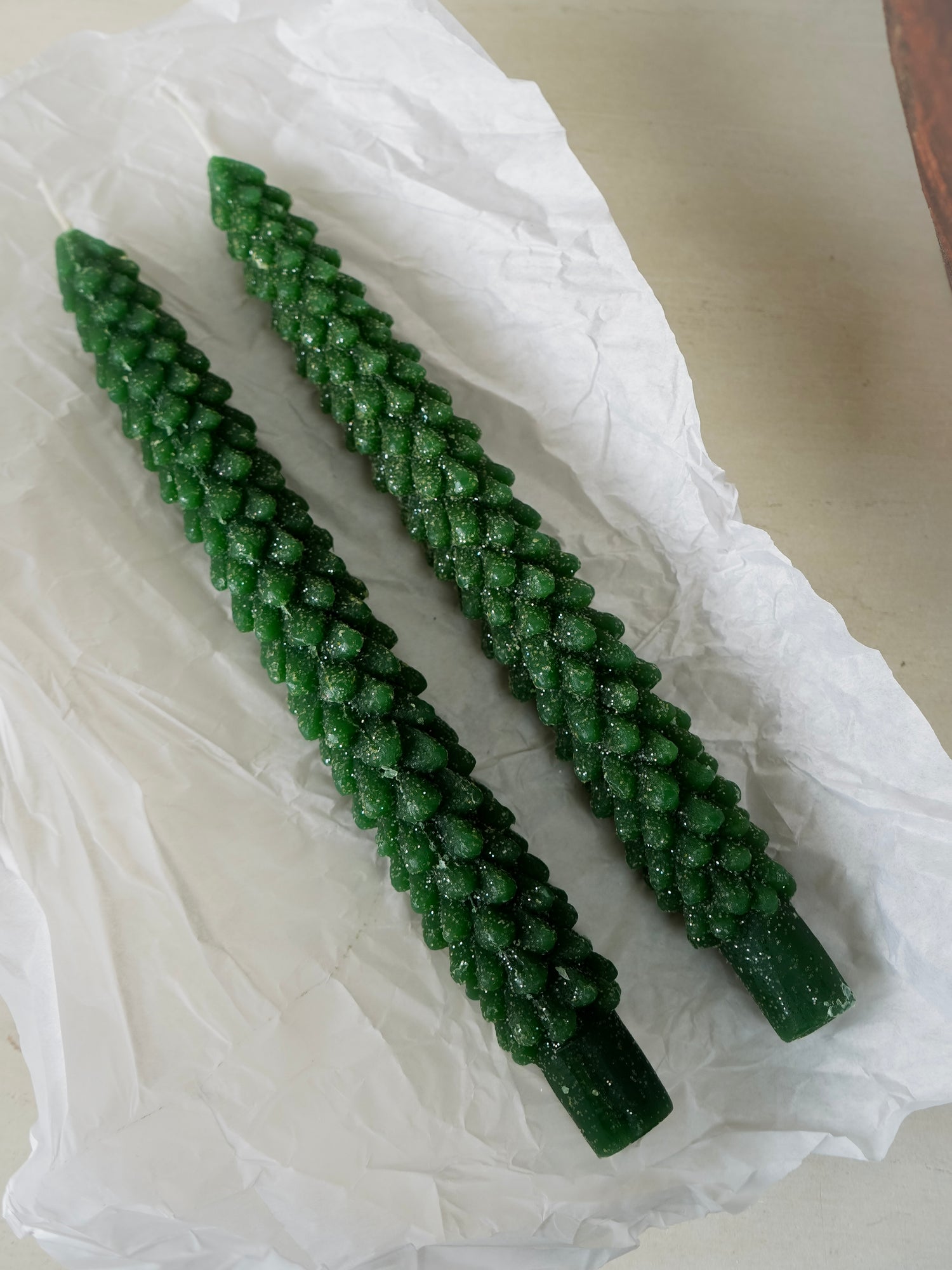 Two green christmas tree dinner candles