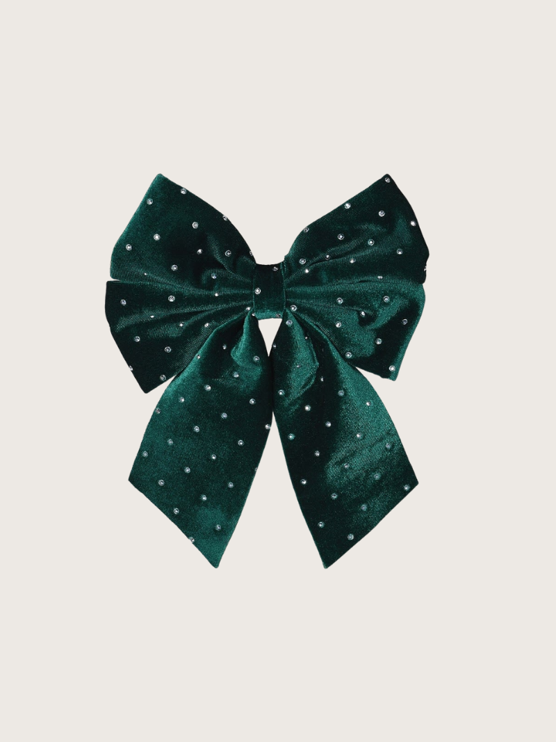 Green bow with small sparkle dots on a light gray background