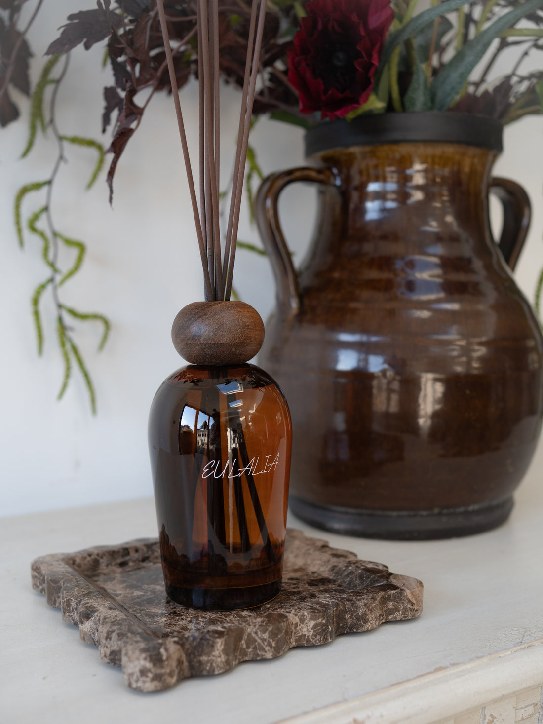 Eulalia Amber Reed Diffuser on brown scalloped marble tray