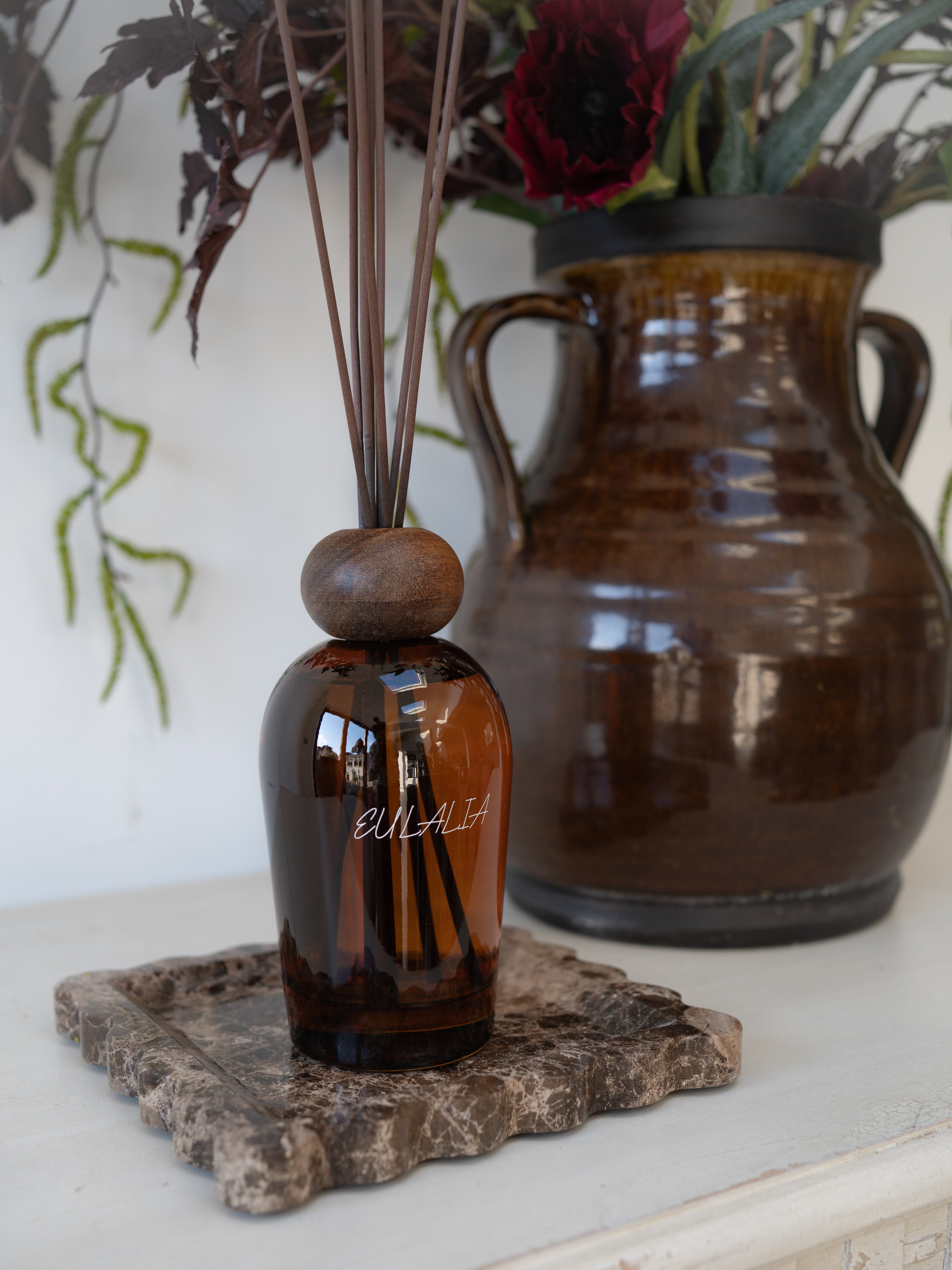 Eulalia Amber Reed Diffuser on brown scalloped marble tray