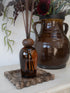 Eulalia Amber Reed Diffuser on brown scalloped marble tray