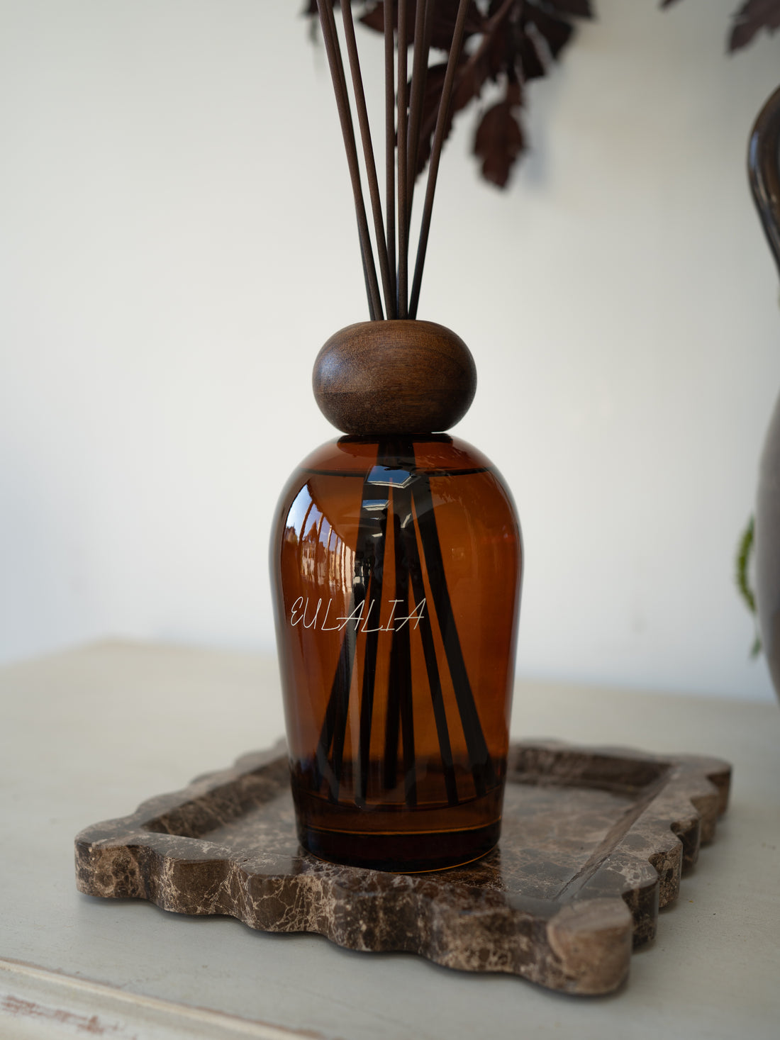 Eulalia Amber Reed Diffuser on scalloped brown marble tray