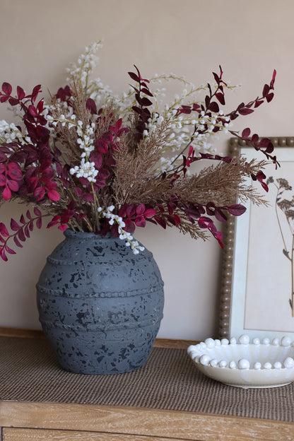 Faux autumn luxury foliage arrangement in charcoal ribbed vase with white bobble bowl and vintage brown framed wall art