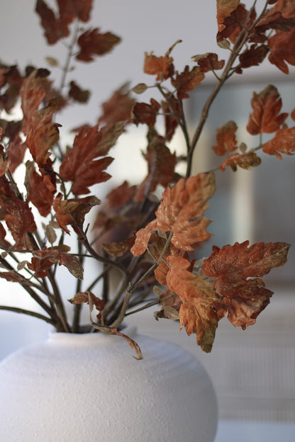 up close of faux autumn leaves spray