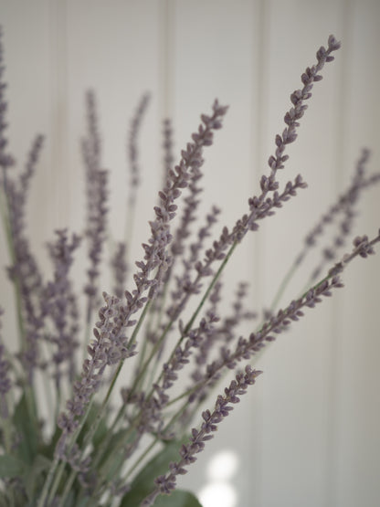Close-up of faux lavender flowers against a neutral background